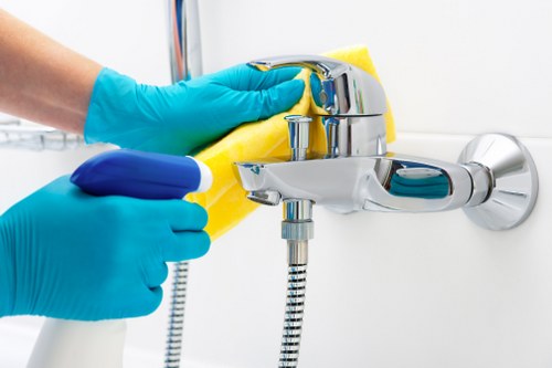 Cleaner in SW8 handling deep cleaning tasks in a modern apartment